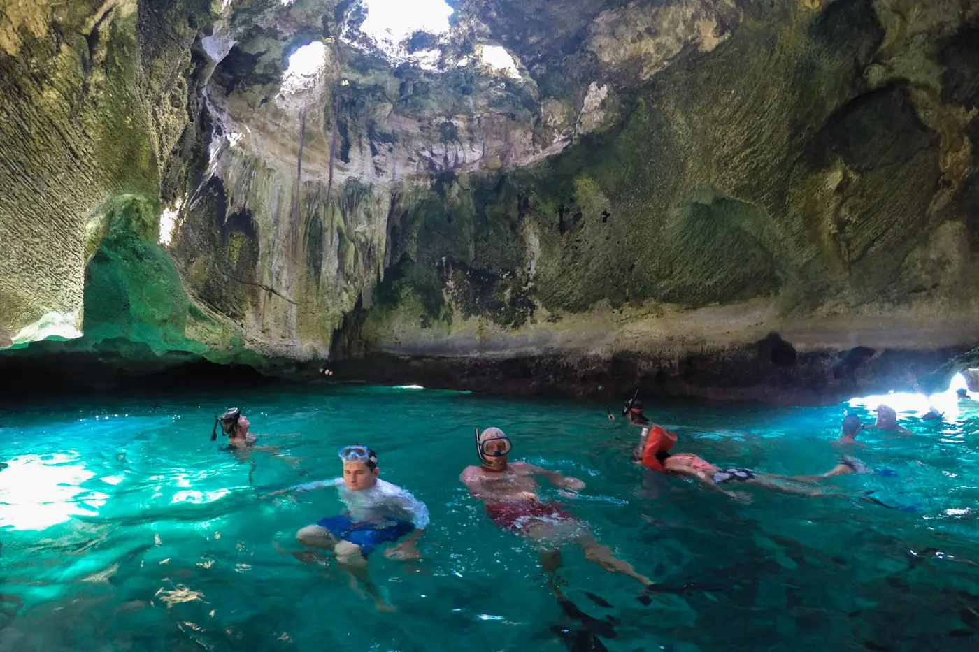 Sunlight streaming into Thunderball Grotto through openings in the cave roof