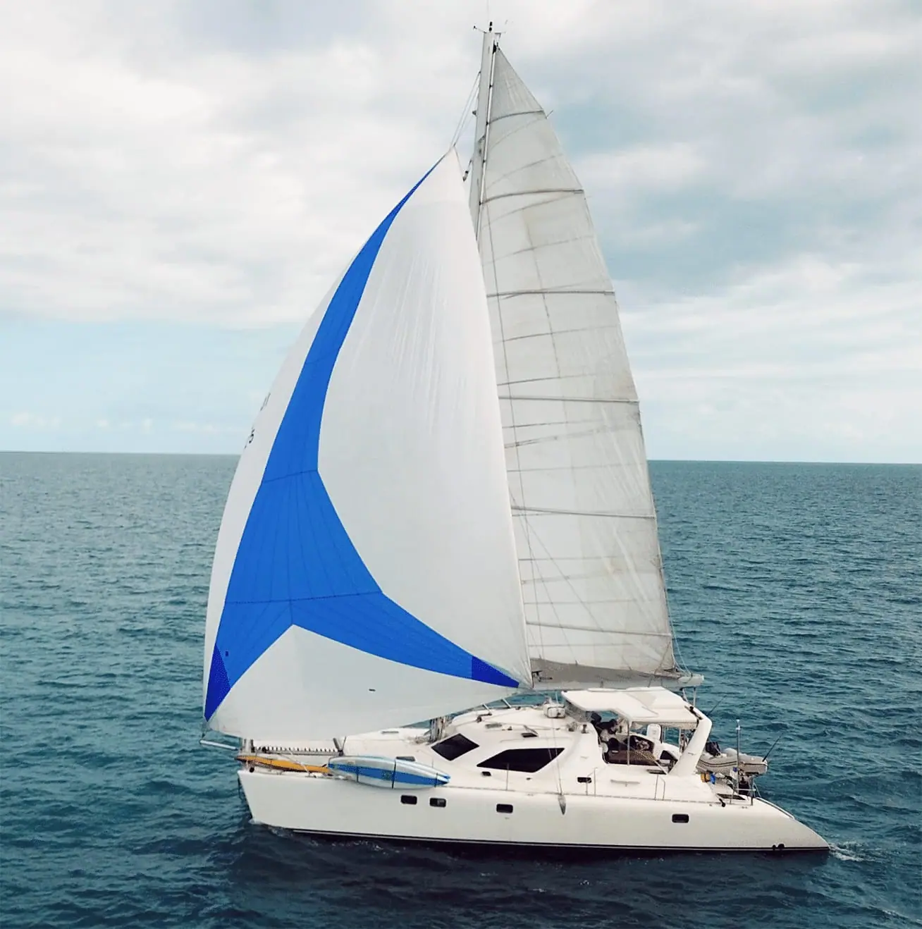 Kiteboarder riding near the anchored Magic Bus catamaran